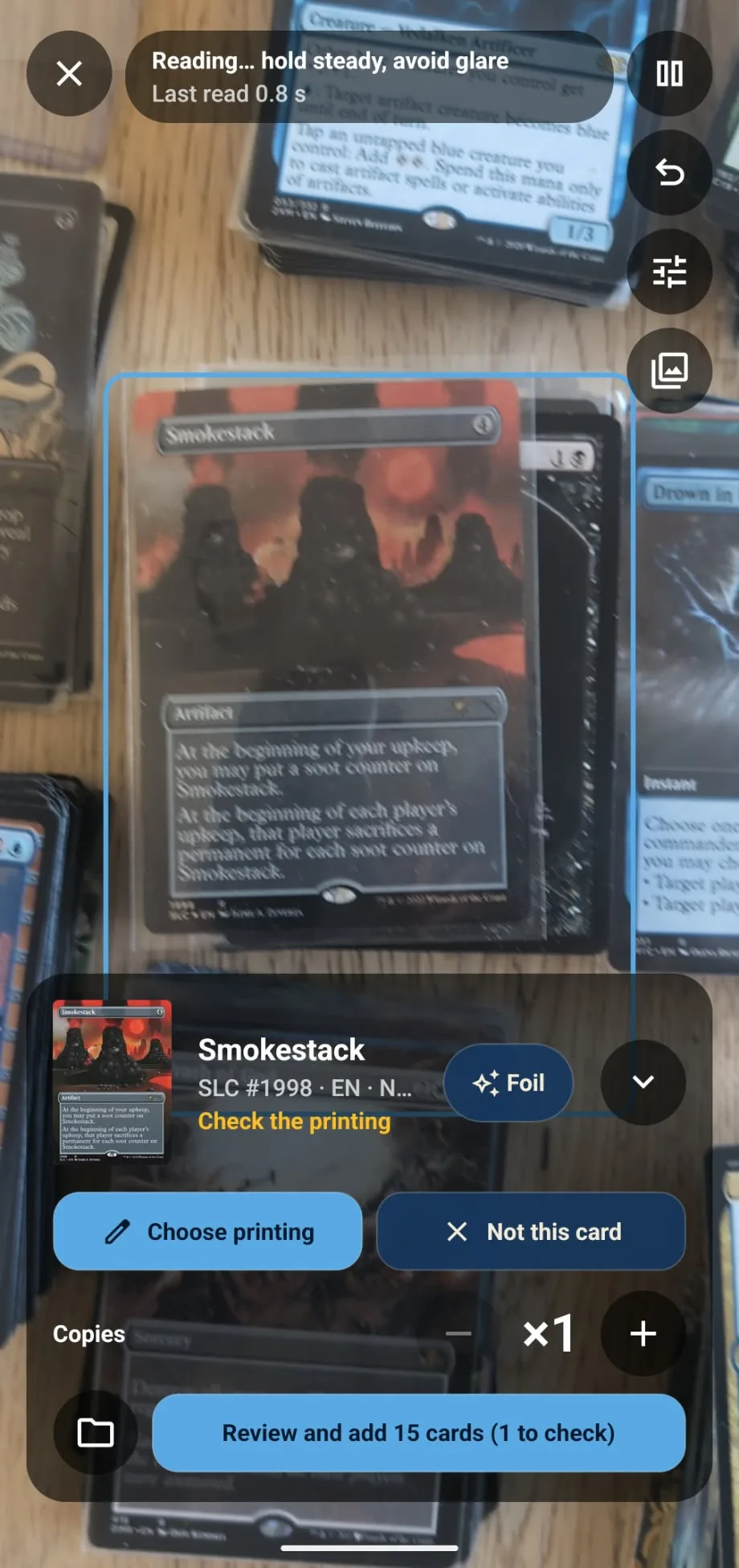 The Deckster scanner reading Smokestack, with 15 cards ready to add